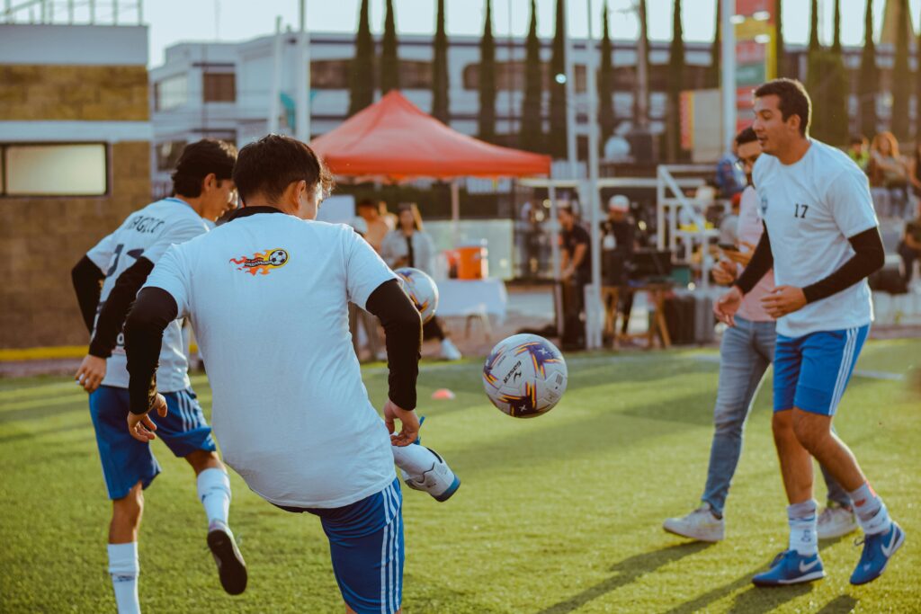 Dynamic shot of amateur soccer players competing in a vibrant outdoor setting.